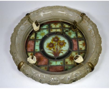An Arts and Crafts leaded centre light shade, daffodil design to centre, with metal rose, circa 1860. Diameter 51cm.