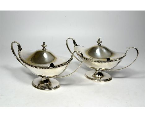 A pair of silver two handled lidded sauce tureens by Thomas Bradbury & Sons, London 1902 & Sheffield 1902. Retailers mark to 