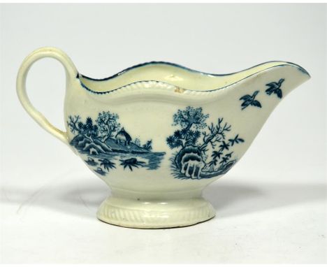 An 18th century Worcester blue and white sauce boat, with printed Chinese fence and floral decoration. Blue crescent mark on 