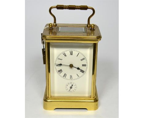 A French 8 Day repeating alarm carriage clock, with Roman numeral dial and alarm dial below, set in a gilt surround and gilt 