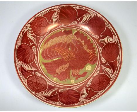 A large William De Morgan ruby and copper lustre dish by Charles Passenger, decorated with an eagle to the centre, the rim wi
