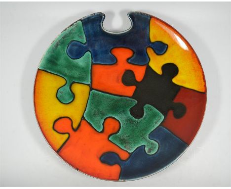 A Poole Pottery studio, limited edition Jigsaw charger 205/250 boxed. Diameter 42cm.