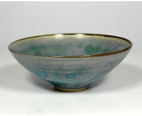 † A Lucie Rie footed bowl, with a blue and powdered green exterior and interior glaze. Impressed artist seal. Diameter 14cm, 