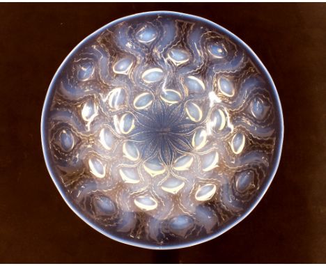 A Lalique glass shallow bowl, with raised flower head decoration, stamped R Lalique, France 25.5cm dia.