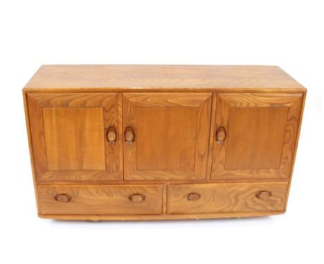 A light Ercol sideboard, fitted cupboards and drawers under - damaged to one handle, 130cm long