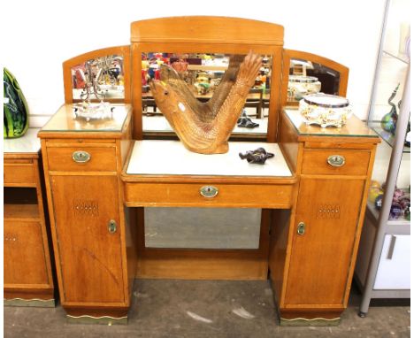 A continental breakfront dressing table, having triple bevelled mirrored back, slides and single drawers above a bow front ce