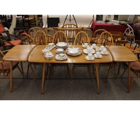 A light Ercol dining table, with two extensions, 239cm fully extended