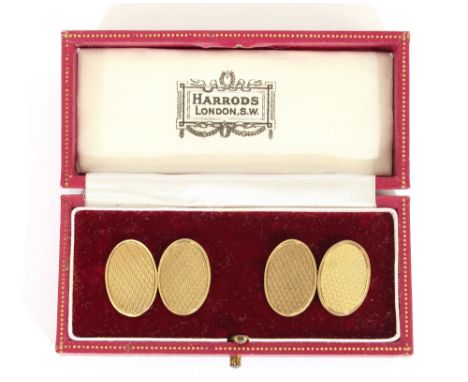 A pair of 9ct gold oval cuff-links, with engine turned decoration in a Harrods box
