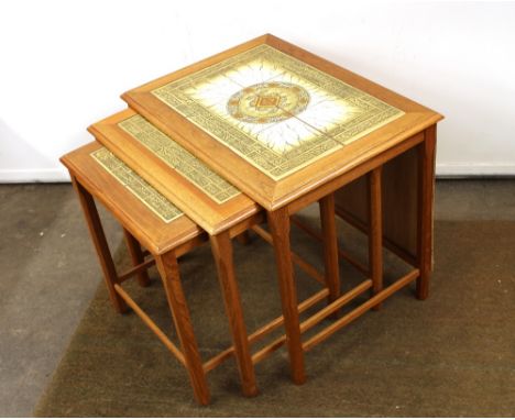 A nest of three teak tile top coffee tables, 55cm wide in extremes