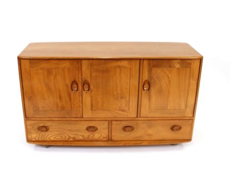 A light Ercol sideboard, fitted cupboards and two drawers to the base, 129cm wide