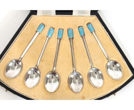 A cased set of six silver and enamel coffee spoons, in fan shaped box