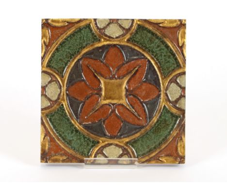 A 20th Century pottery tile, with raised foliate and gilt heightened decoration, 18.5cm