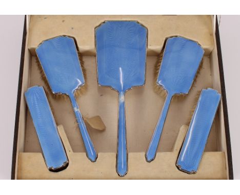 A cased vanity set, with blue enamel decoration