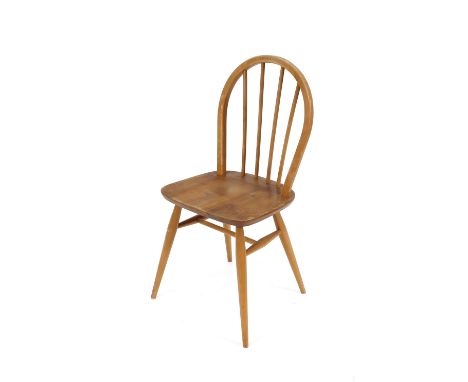 A set of four Ercol stick back dining chairs