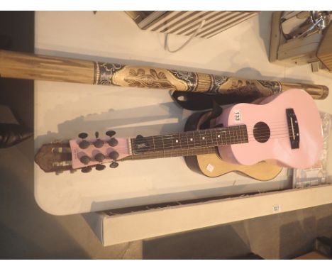 Two childs guitars and a didgeridoo