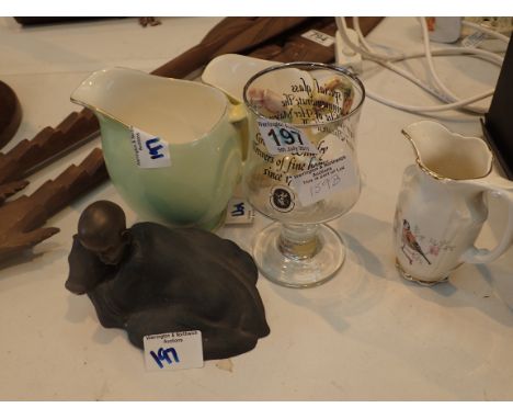 Cast African figure, two Royal Winton jugs and a Worcester jug 