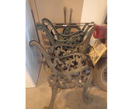 Two pairs of cast iron bench ends and a pair of table supports 