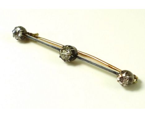 A three stone diamond bar brooch, the central diamond of approximately 0.6ct, 5.5 by 5.4 by 3.4mm, flanked by a diamond of ap