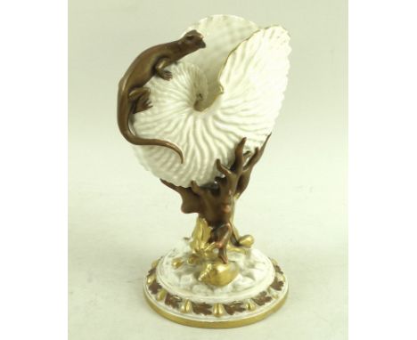 A Royal Worcester nautilus shell with applied salamander, the stem formed as coral and seaweed, base strewn with sea shells, 