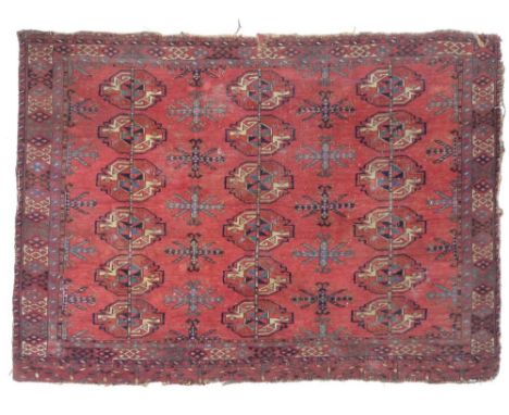 A finely knotted Persian Tekke rug, early 20th century, with red ground, eighteen guls to the field, geometric border, 89 by 