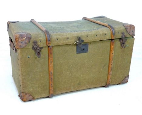 A mid 20th century green canvas travelling trunk, wooden bound, metal fittings and with leather carry handles, named to lid '