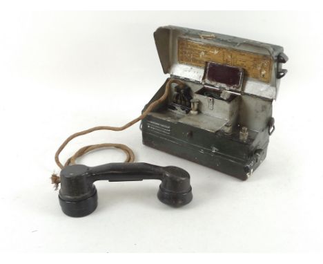 A collection of mostly military communications equipment, including a WWII Army field phone, telephone set L Mk 1, several se