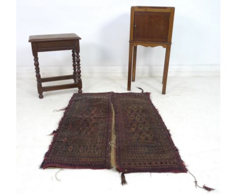 A Persian camel bag, dark blue and red with geometric decoration, 74 by 97cm, an 18th century oak barley twist stool, 42 by 2