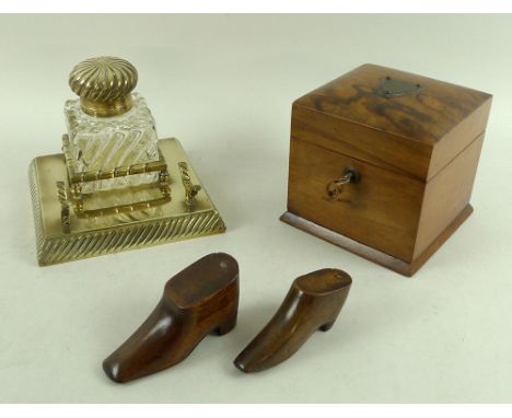 An early 20th century inkwell with brass stand, lobed wrythen detailing to both lid and glass body, pen stand to base, 16.5 b