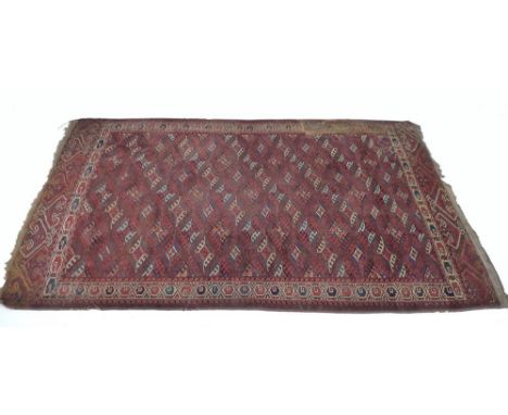 A finely knotted Persian Tekke rug, early 20th century, with red ground, repeating diamond guls with latchhook edges to the f