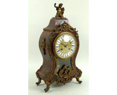 A French Napoleon III, late 19th century, boulle and tortoiseshell mantel clock, of bombe form with gilt metal figural surmou