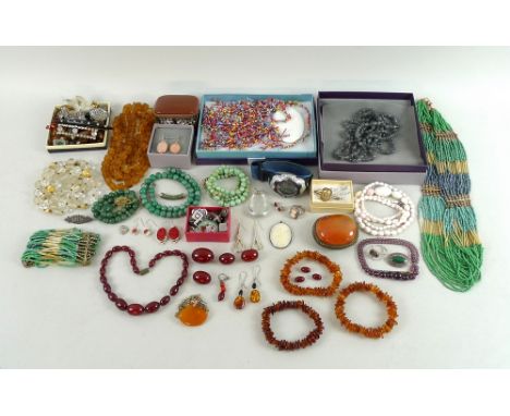 A group of silver and vintage and later costume jewellery, including amber necklaces, bracelets and earrings, a jade pendant,