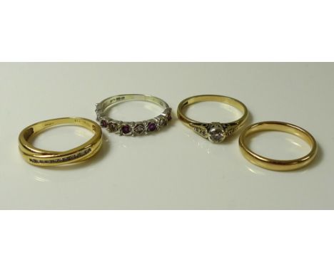 A group of four gold rings, comprising an 18ct gold and diamond cross over ring, set with a line of eleven small diamonds, si