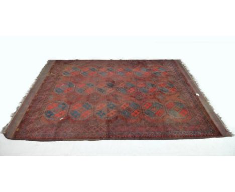 A finely knotted Persian Hamadan/Tekke rug, early 20th century, with red/brown ground, eighteen guls to the field, geometric 