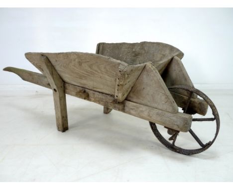 An early 20th century wooden garden wheelbarrow, 71 by 170 by 58cm high.Provenance: The Estate of Mr Joseph B. Hay, son of Ma