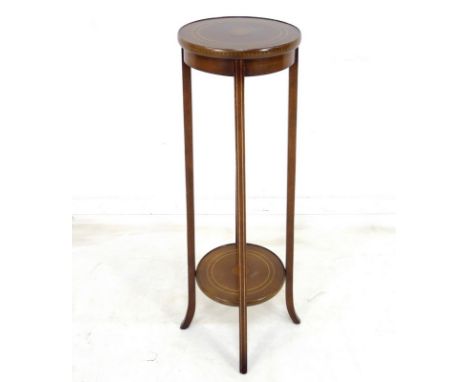 An Edwardian mahogany jardiniere stand, the circular surface and slender legs inlaid with satinwood marquetry, with lower tie