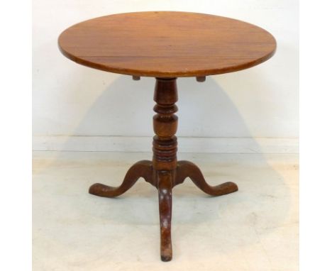 A Georgian mahogany single pedestal tilt top table, raised on tripod legs.
