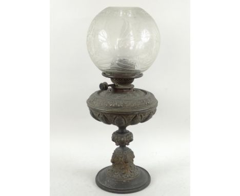 A Victorian cast metal oil lamp, of lobed form on circular base, relief decorated with lions and cherub masks, scales and fol