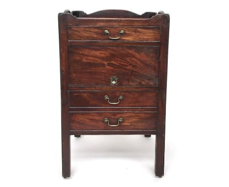 A George III mahogany bedside cabinet, the full gallery top with pierced hand holds above a drawer, tambour, and converted co