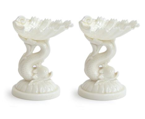 A pair of Royal Worcester shell sweetmeat dishes in white, supported on the tail of a dolphin, shape G49, each 11cmHProvenanc