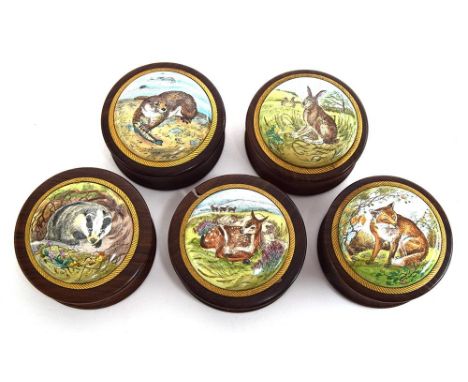 A set of five modern enamel topped wooden circular boxes, the tops painted brown hare, badger, otter, red deer's calf and red