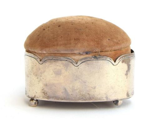 An oval silver pin cushion on ball feet, London 1900, 7.7cm longProvenance: from the estate of Elizabeth Pepys-Cockerell, who