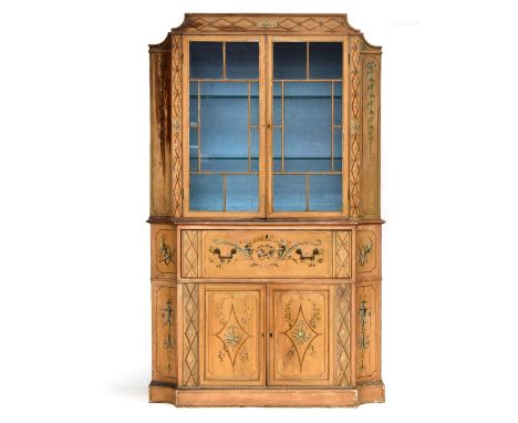 A George III painted bookcase cabinet, with tablet cresting and astragal glazed doors flanked by concave canted angles with m