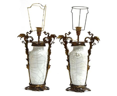 A pair of Chinese ormolu mounted crackle glaze vases, each with dragon handles, adapted as lamps, with pleated silk shades, e
