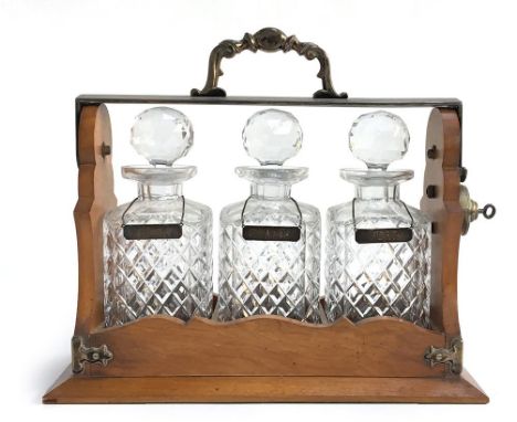 A 19th century oak cased three decanter Tantalus by Betjemann's having silver plated mounts and makers stamp to side, complet