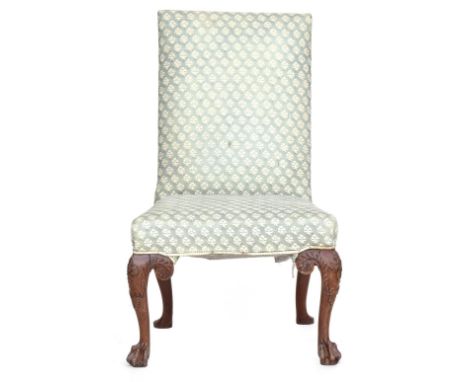 A George I carved walnut side chair with upholstered back and stuffover seat on cabriole legs, foliate carved knees and paw f