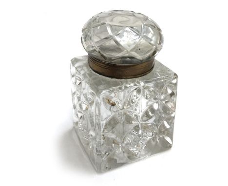 An early 20th century heavy glass inkwell of square section, with brass rim, 9.8cmH 