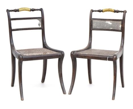 A pair of Regency grained rosewood side chairs, with split cane seats and splats, parcel gilt roped top rails and sabre legsP