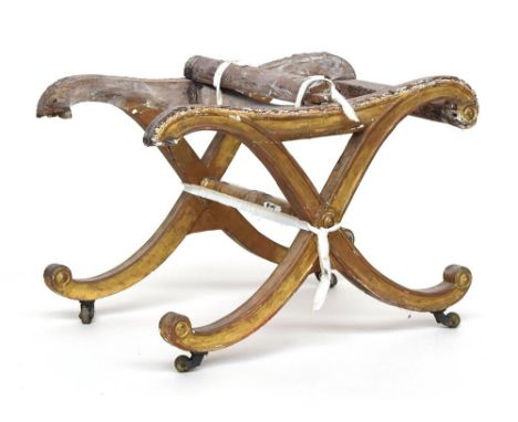 A Regency giltwood cross framed stool, on brass casters, damaged, 41cmHProvenance: from the estate of Elizabeth Pepys-Cockere