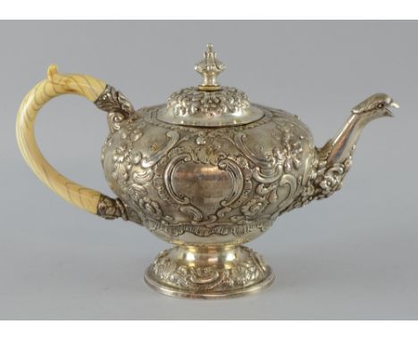 George III silver teapot with later embossed decoration, bird's head spout, with ivory handle on round foot, by William Fount