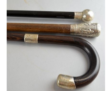 George V silver mounted walking stick, the ball end with scrolling decoration, London, 1920, another with the handle embossed